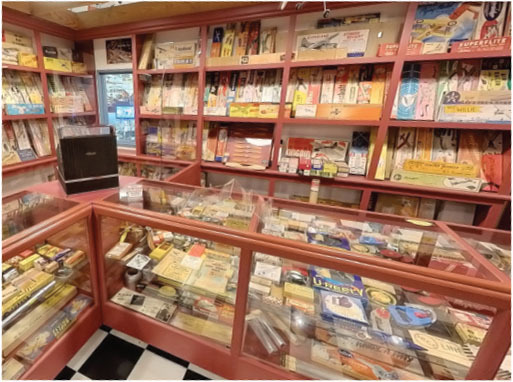 Vintage toy store with glass display cases and shelves full of model kits and toys.