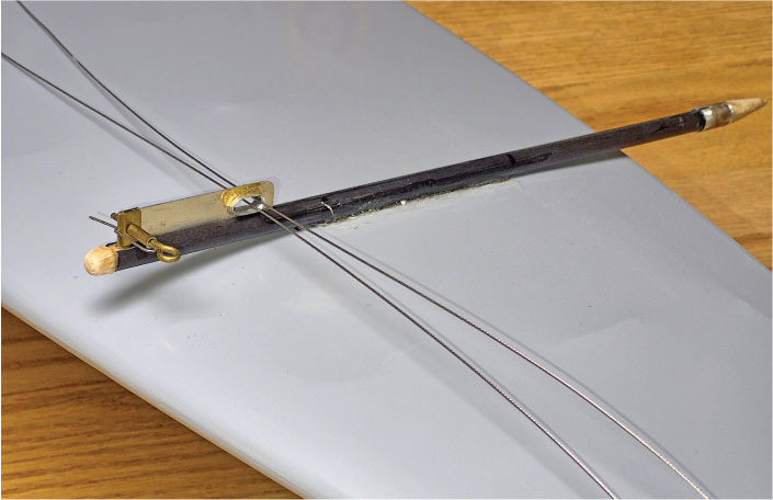 Model airplane wing with a mechanical linkage attached.