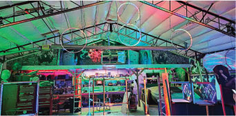 Colorful warehouse interior with hanging hoops and vivid lighting.