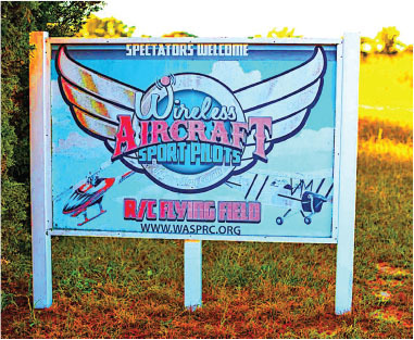 Wireless Aircraft Sport Pilots sign, with wing graphic and web address www.wasprc.org.