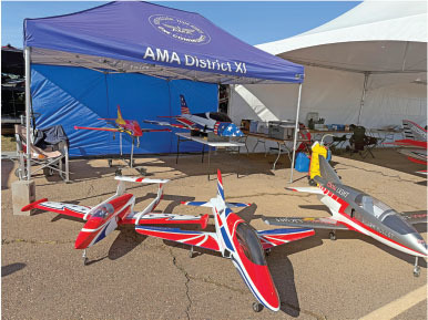 Model airplanes displayed under a blue AMA District XI tent.