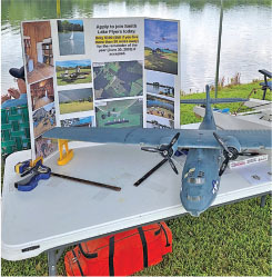 Model airplane on a table with display board and tools.