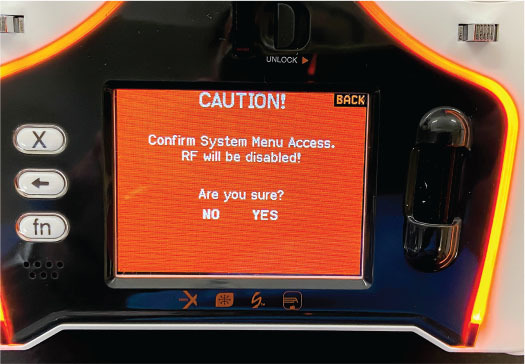 Device screen with orange caution warning and yes/no options.