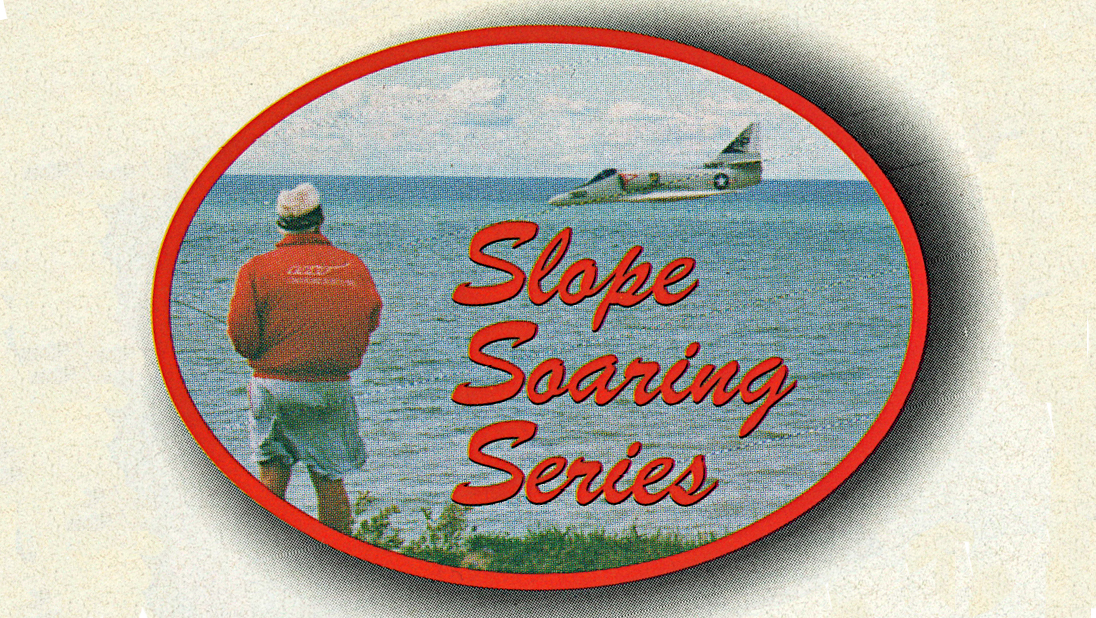 Man in red jacket by the sea with a flying model plane, text: "Slope Soaring Series."