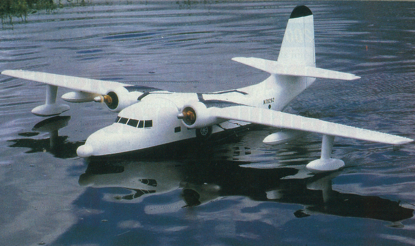 White seaplane floating on calm water.