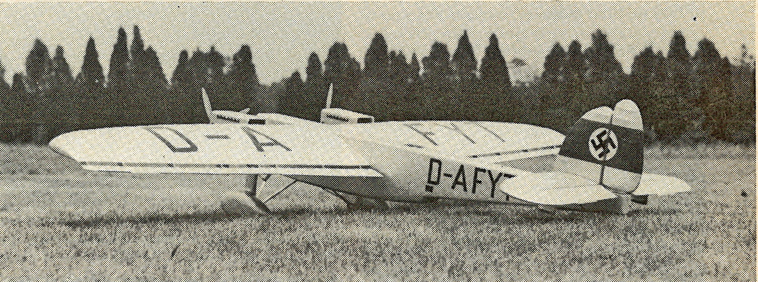 Vintage aircraft on grass, tail features a swastika insignia.