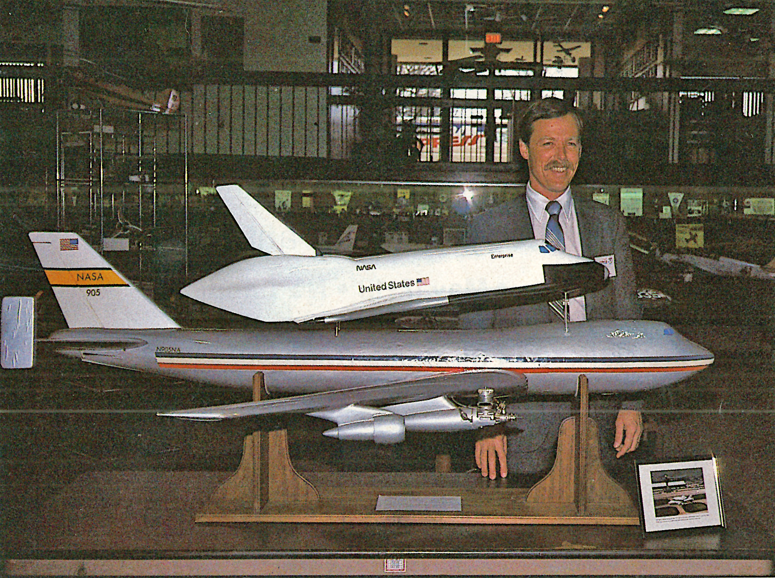 Model of Shuttle on Boeing 747 with person standing behind in a display setting.