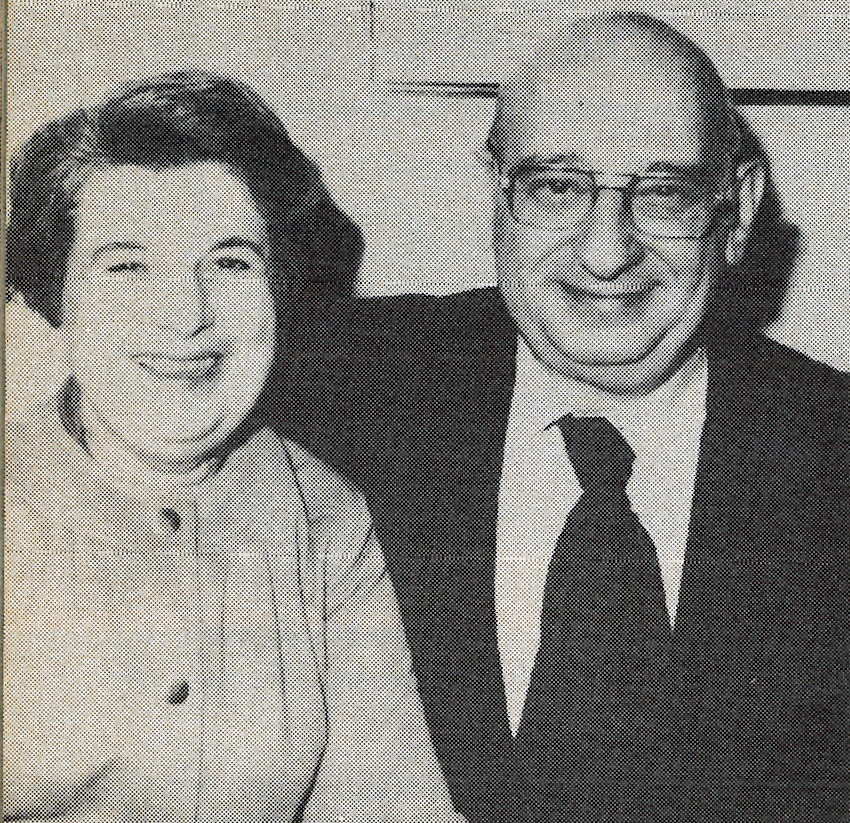 Smiling older couple in a black and white photo.