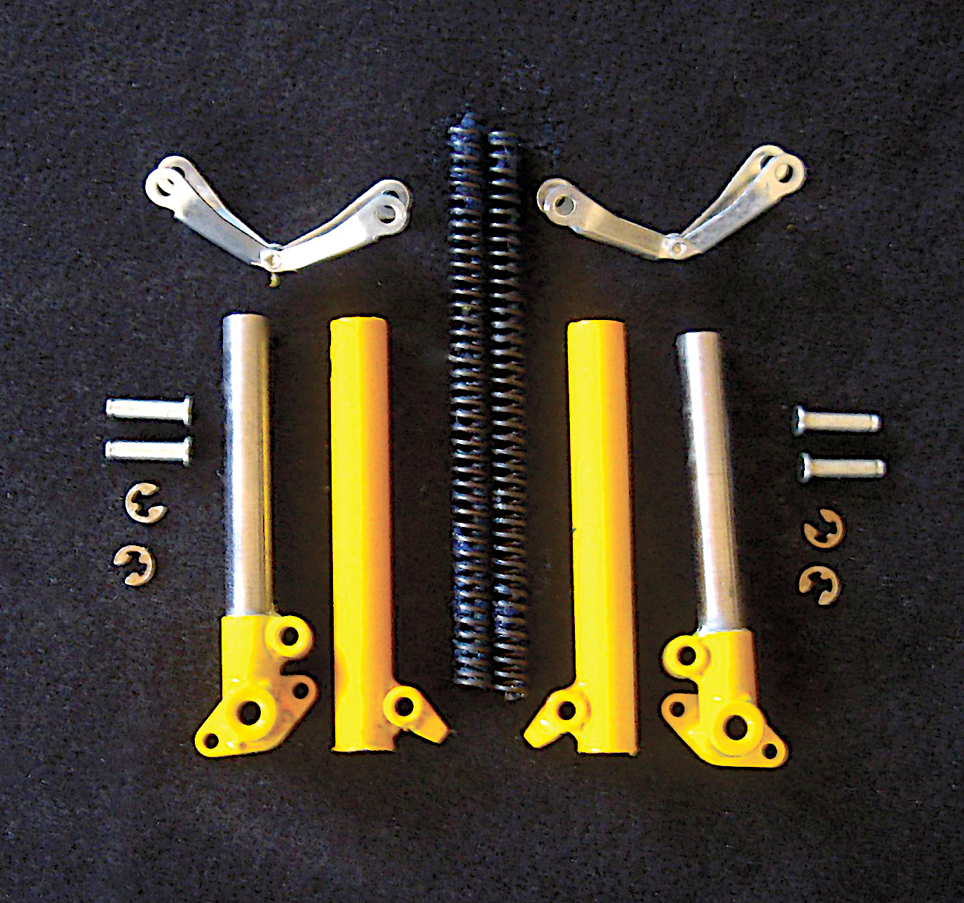 Yellow and silver bike rack parts on a black background.