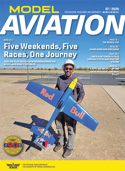 Model Aviation magazine cover, man holding a model Red Bull plane.