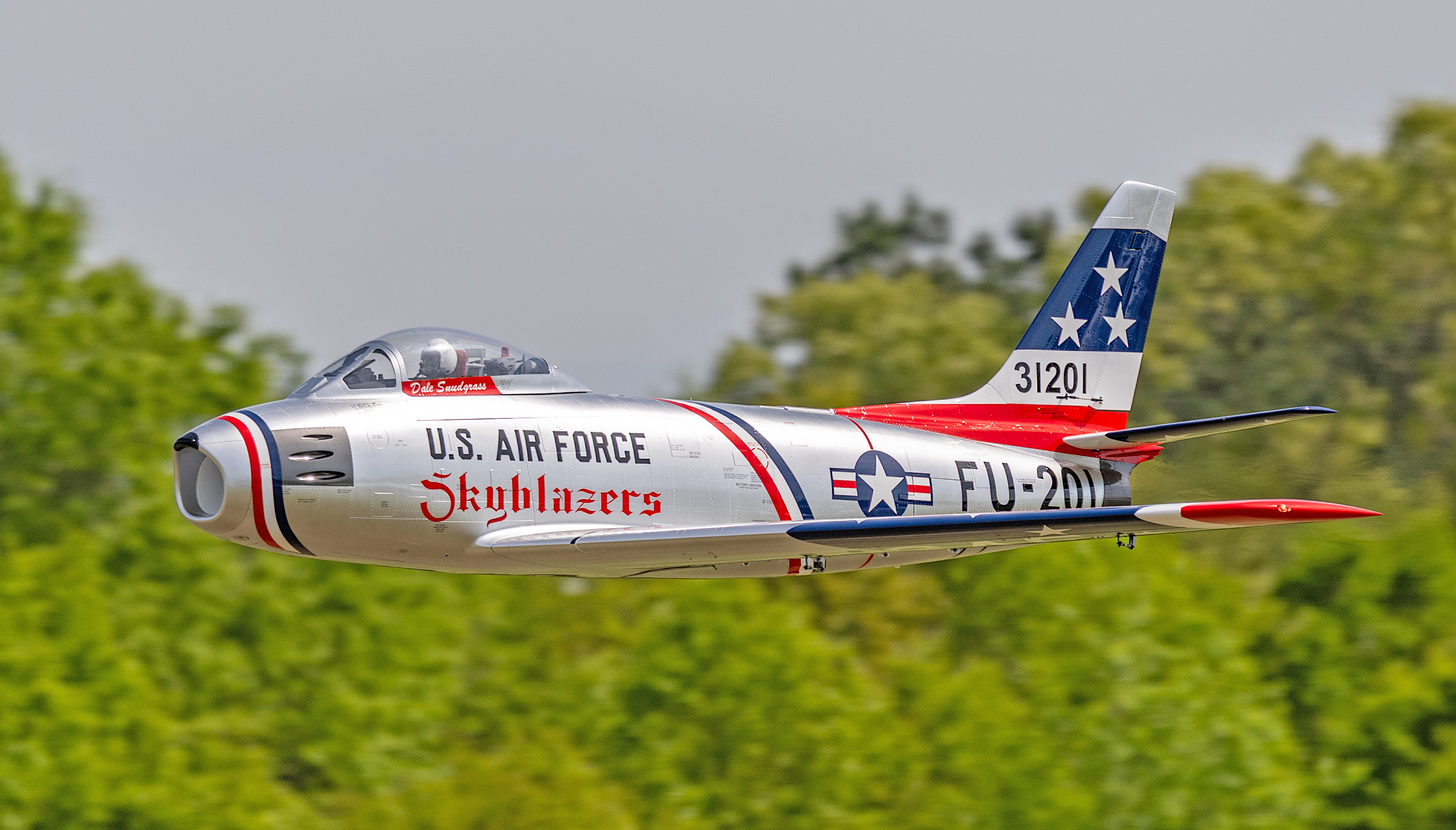 U.S. Air Force jet model flying over trees, marked "Skyblazers" and "FU-201."