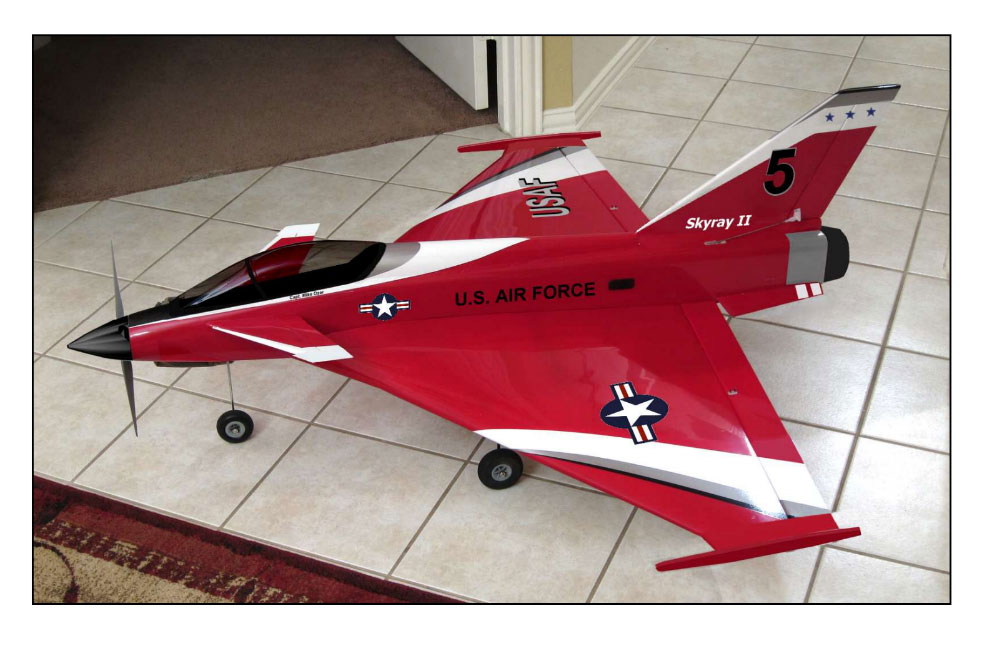 Red model jet with "U.S. Air Force" text and star emblem on tiled floor.