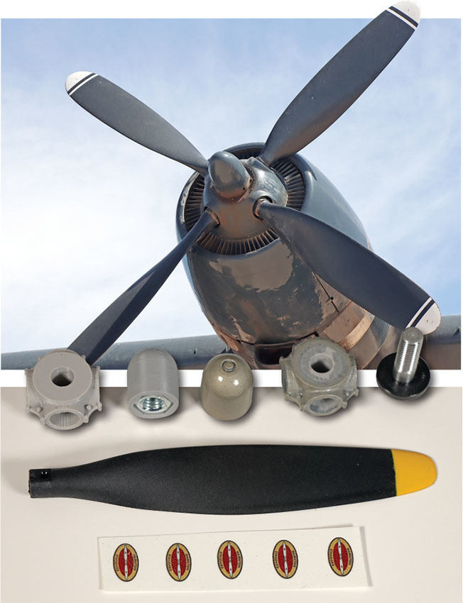 Propeller with blue sky and three spare parts below.