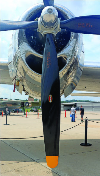 Propeller of a vintage airplane seen from the front at an airshow.
