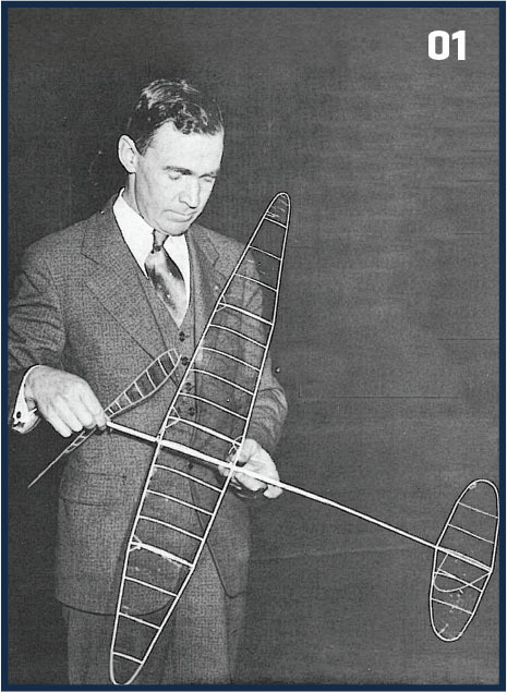 Man holding a model airplane, number "01" in corner.