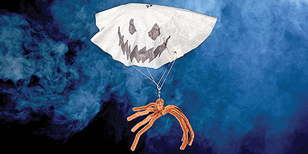 A ghostly parachute with a spooky face floats against a smoky blue background.