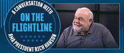 A man smiling; text reads "A Conversation with AMA President Rich Hanson On The Flightline."