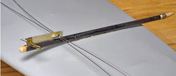 Black slingshot style catapult on a gray surface.