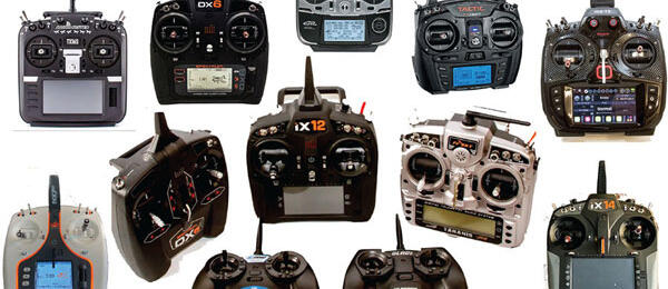 Various remote control transmitters arranged on a white background.