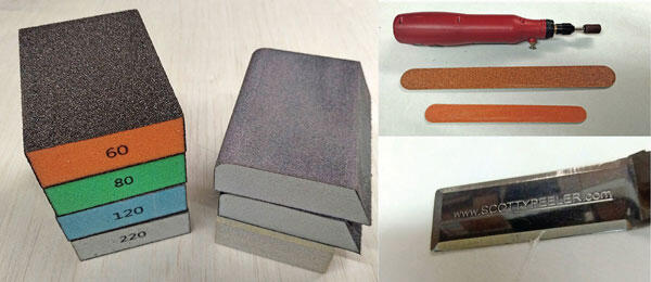 Sanding blocks, file, sanding sticks, and a red-handled tool on a white surface.