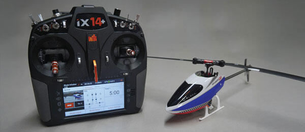 Remote control and miniature helicopter on display.
