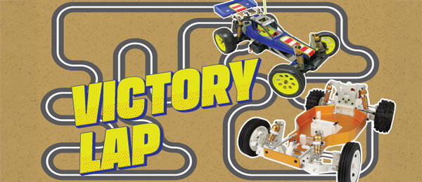 VICTORY LAP text with two toy cars on a race track.