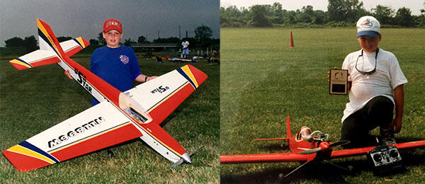 Andrew Jesky with model airplanes on a grassy field, one holding a plaque.