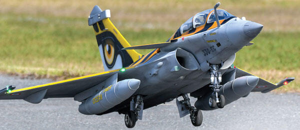 Jet with yellow and black tail landing on runway.