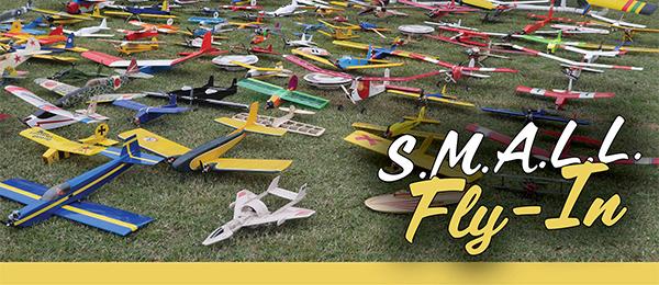 Model airplanes on grass, text reads "S.M.A.L.L. Fly-In".
