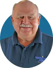 Smiling man in blue polo shirt with AMA logo on a blue background.