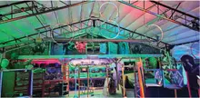 Colorful warehouse interior with hanging hoops and vivid lighting.