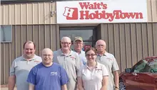 Group of six people in front of Walt's HobbyTown store.