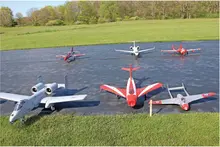 Model airplanes on a grassy field runway.