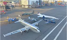 Model airplanes displayed on asphalt, various sizes and colors, including a U.S. Air Force plane.